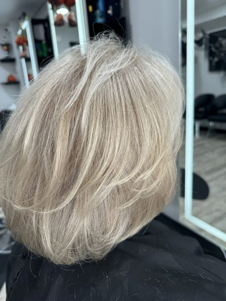 A layered bob with bright blonde highlights, seen from the back